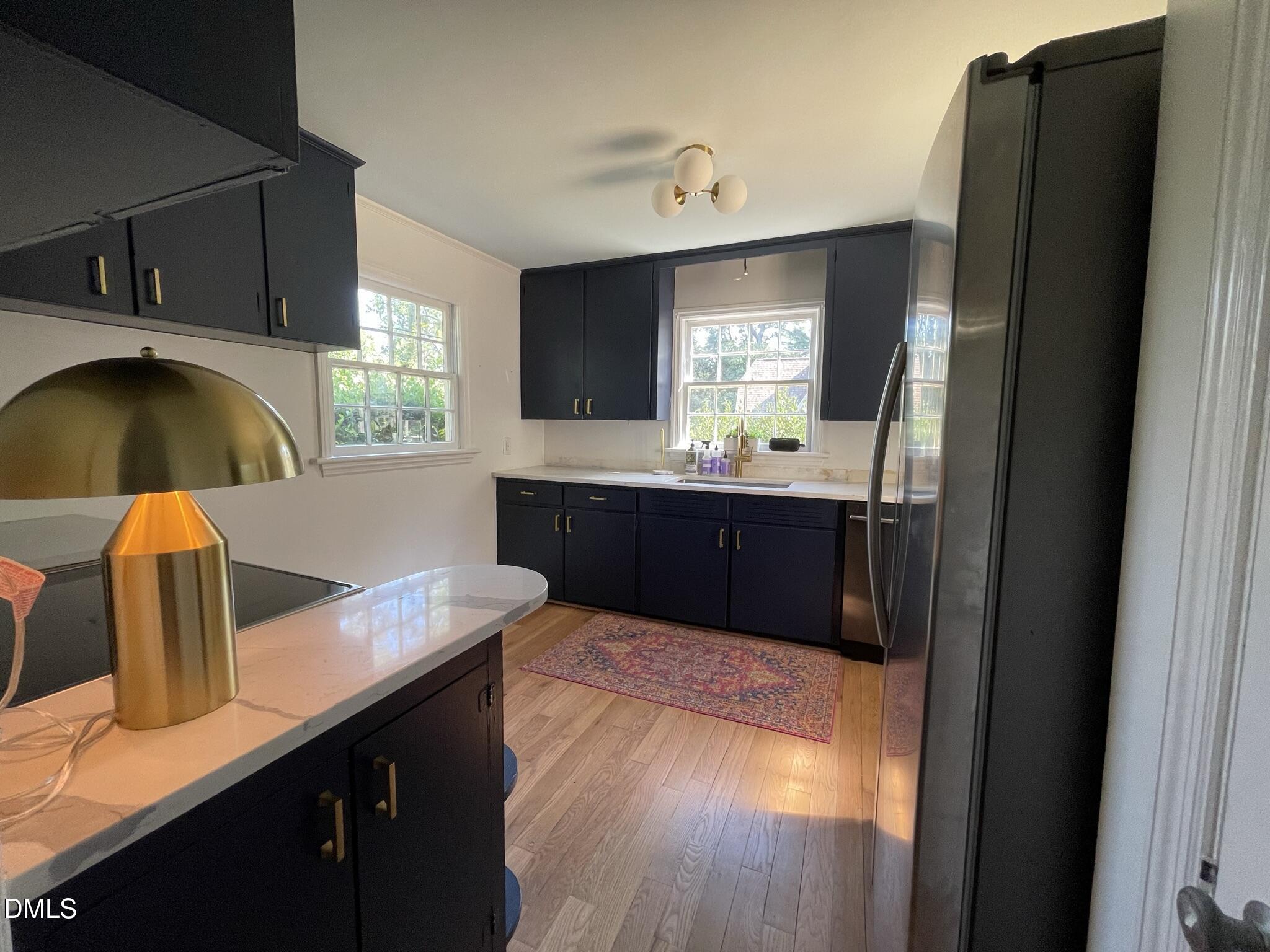 1009 Canterbury Road Raleigh, NC 27607 - Photo 3 of 31 a kitchen with kitchen island a sink appliances and a window