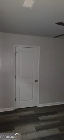 a room with a wooden floor and cabinets