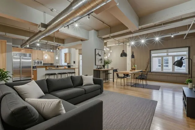 a spacious bedroom with a bed and a dresser