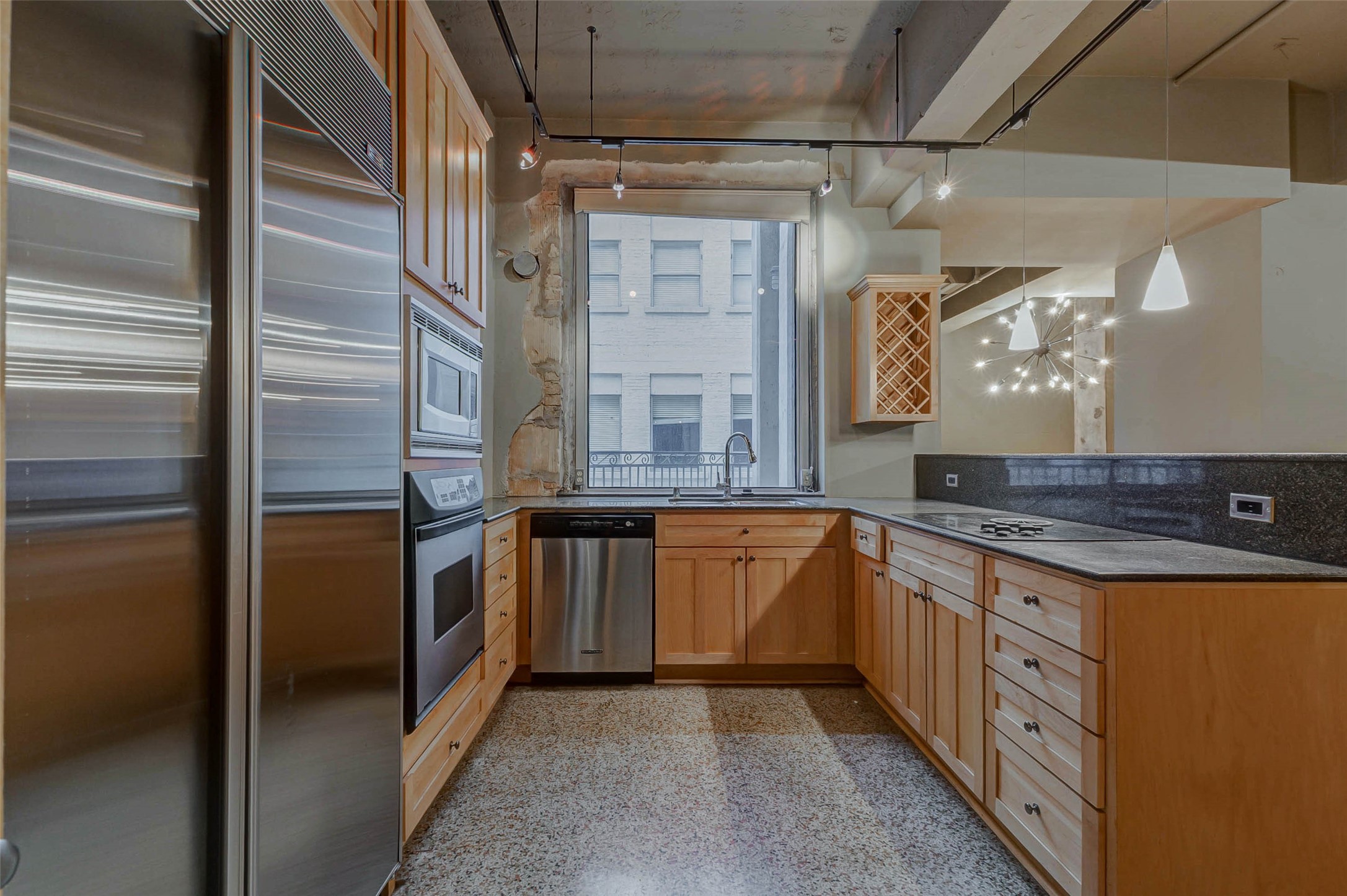 711 Main Street, Unit 505 Houston, TX 77002 - Photo 16 of 47 a kitchen with stainless steel appliances granite countertop a refrigerator and a sink