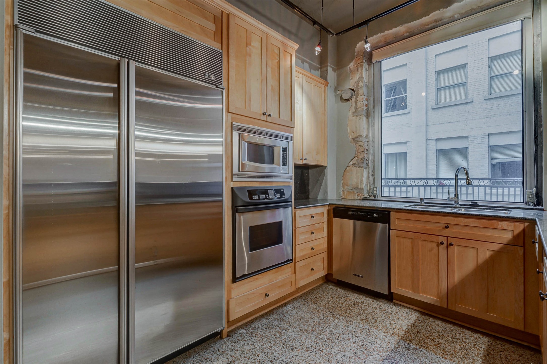 711 Main Street, Unit 505 Houston, TX 77002 - Photo 17 of 47 a kitchen with stainless steel appliances granite countertop a refrigerator and a sink