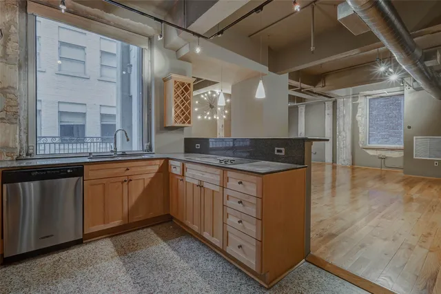 a kitchen with granite countertop a sink and cabinets
