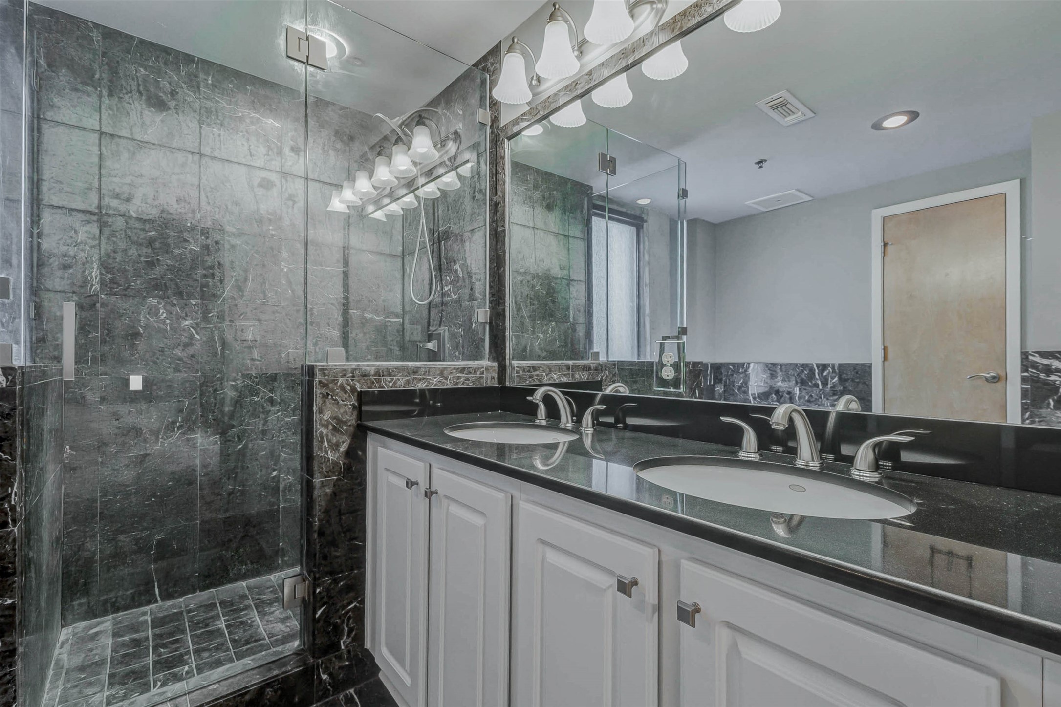 711 Main Street, Unit 505 Houston, TX 77002 - Photo 31 of 47 a bathroom with double sink and a mirror