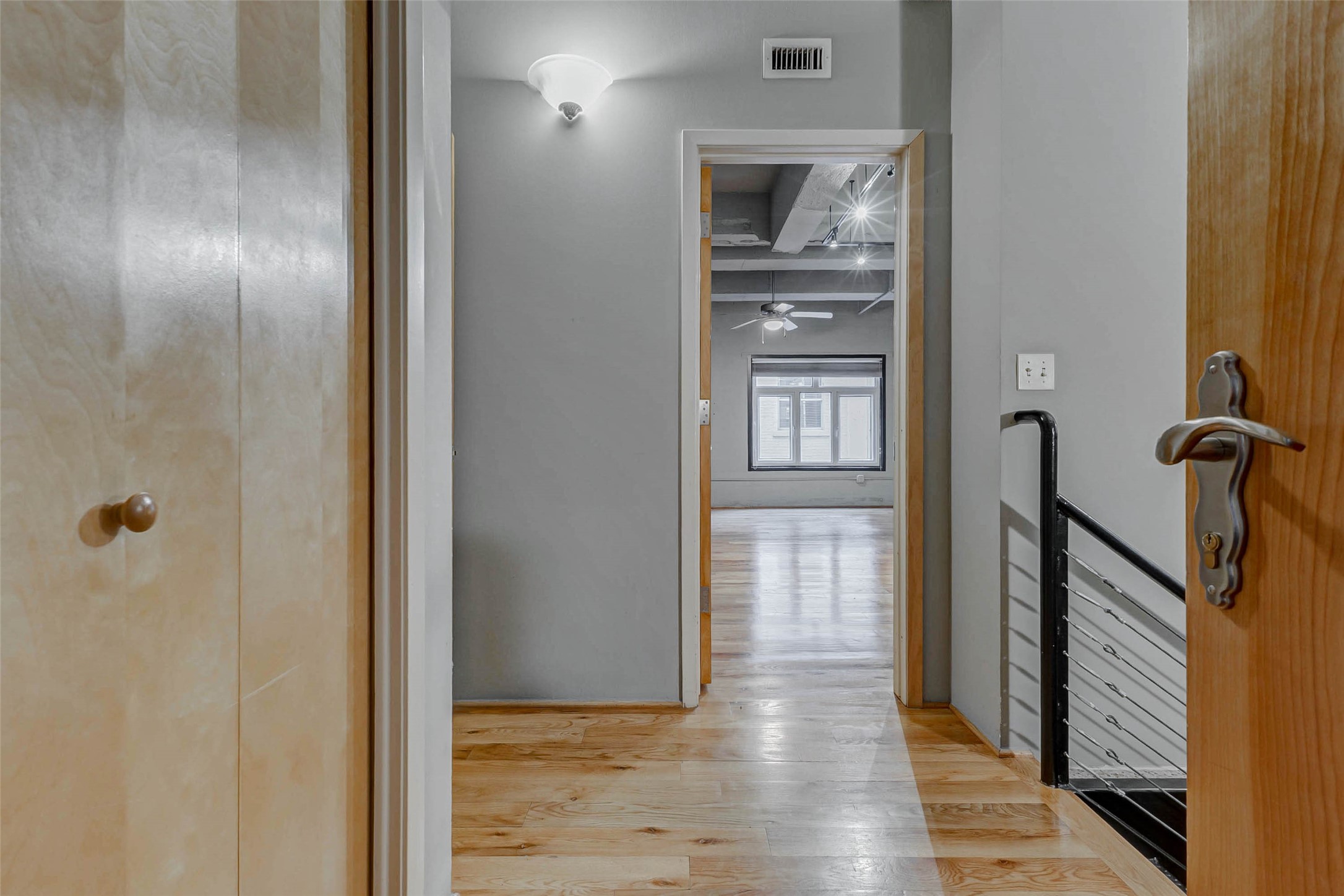 711 Main Street, Unit 505 Houston, TX 77002 - Photo 38 of 47 a view of a hallway with wooden floor and staircase