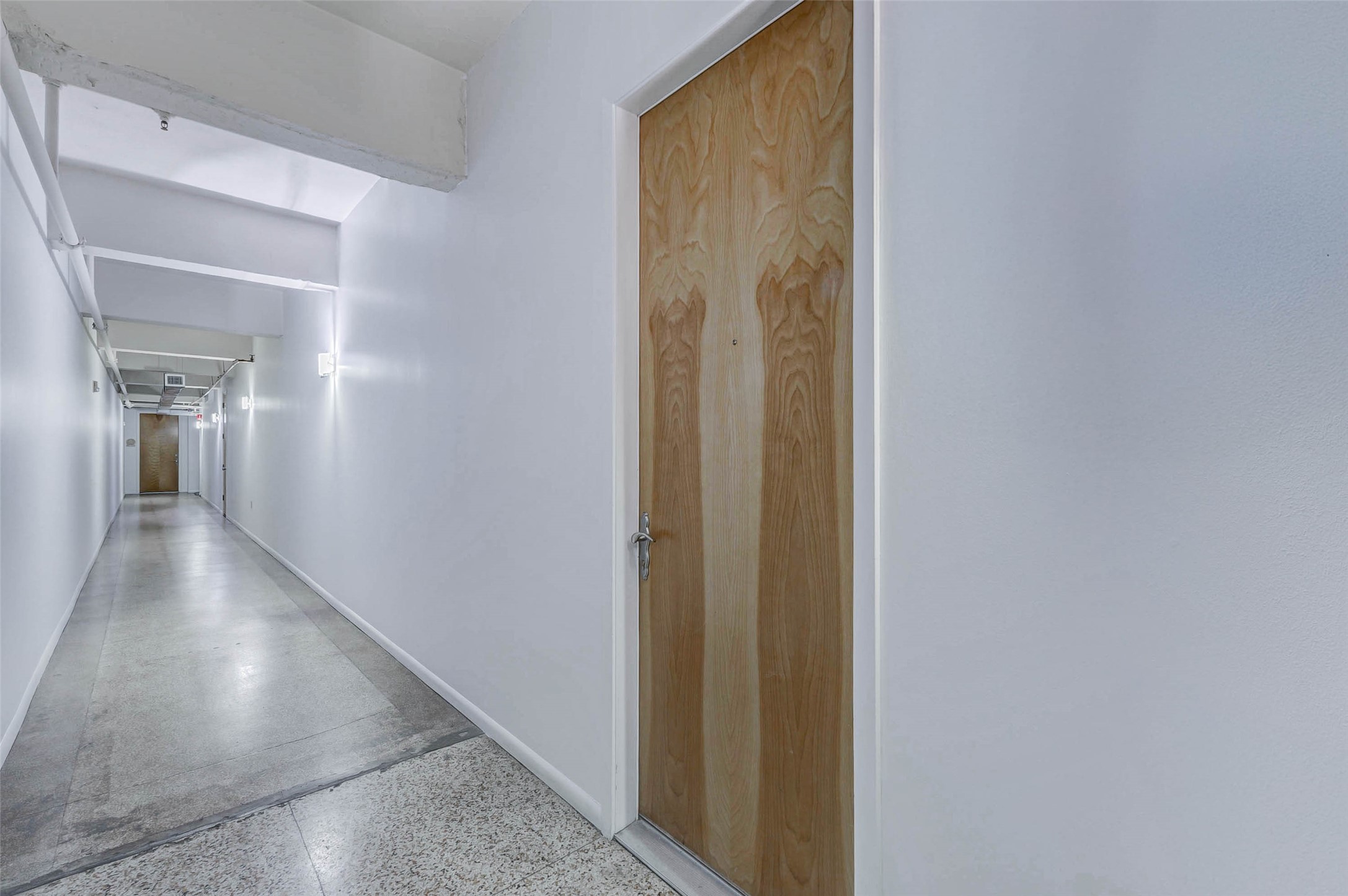 711 Main Street, Unit 505 Houston, TX 77002 - Photo 8 of 47 a view of a hallway with wooden floor
