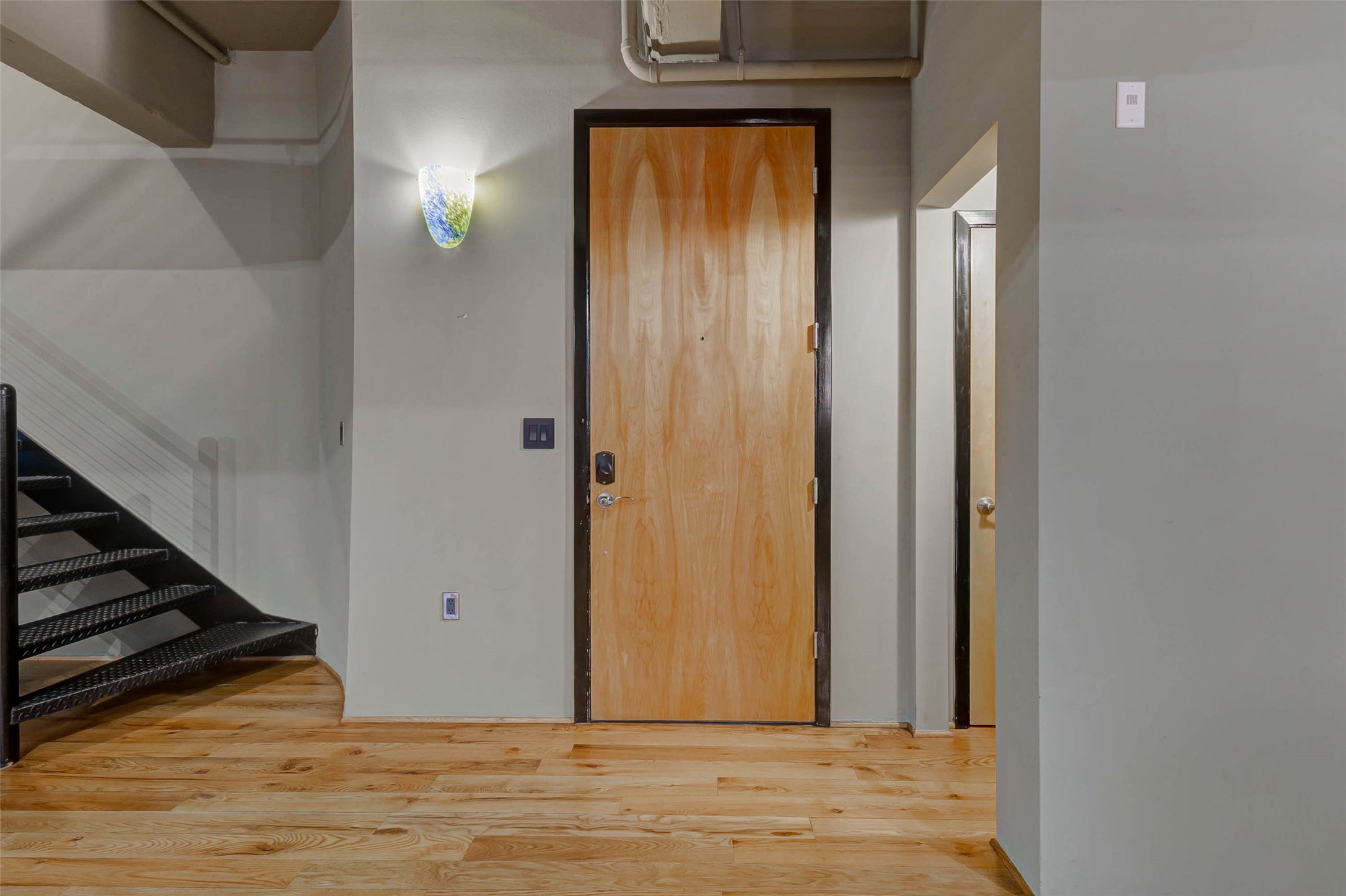 711 Main Street, Unit 505 Houston, TX 77002 - Photo 10 of 47 a view of a livingroom with wooden floor and staircase