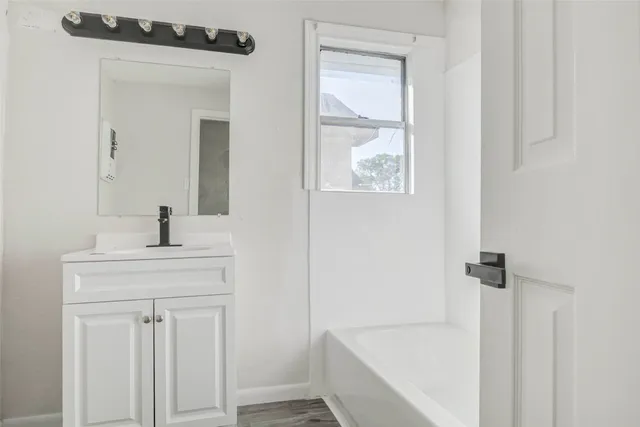 a bathroom with a sink a mirror and shower