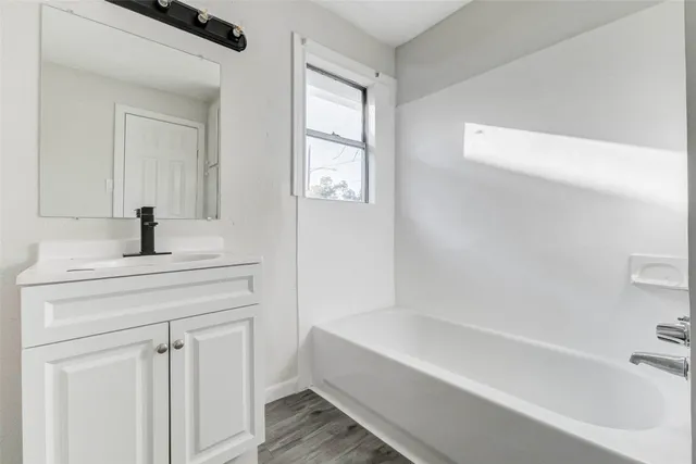a bathroom with a bathtub and a sink