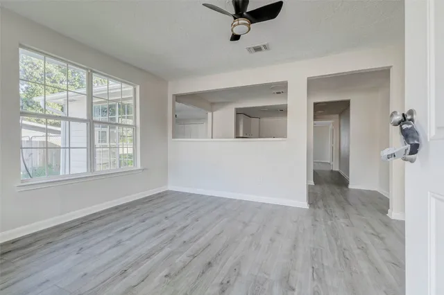wooden floor in an empty room with a window