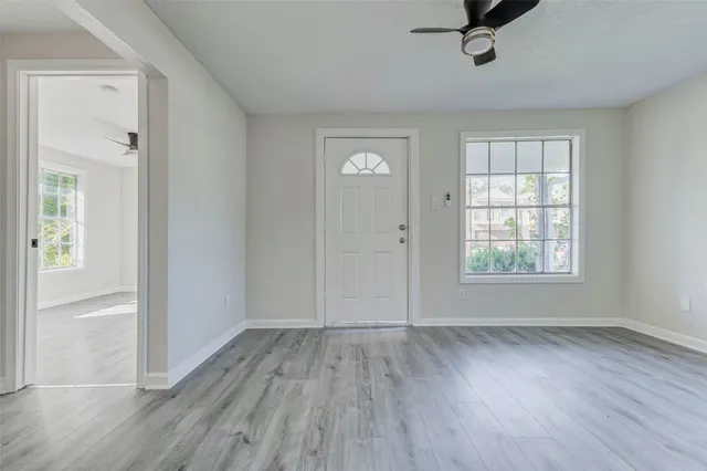 wooden floor in an empty room with a window