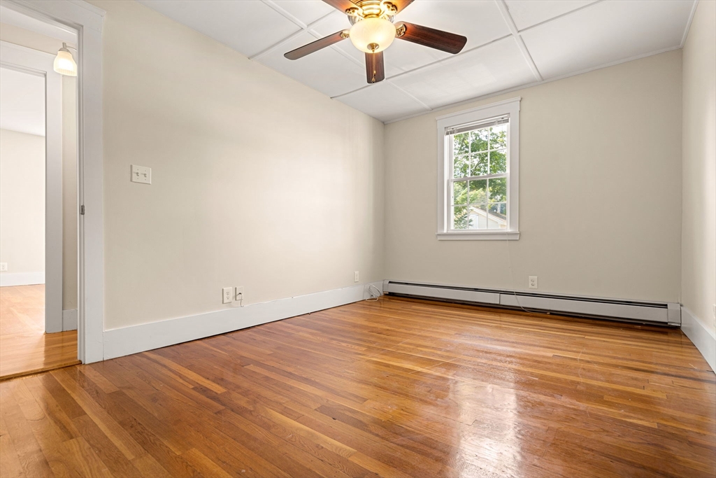 12 Chestnut Street Danvers, MA 01923 - Photo 28 of 37 an empty room with wooden floor chandelier fan and windows