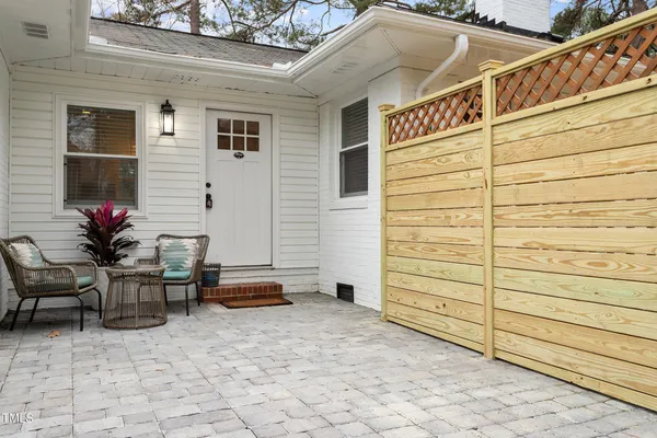 a backyard of a house with outdoor seating