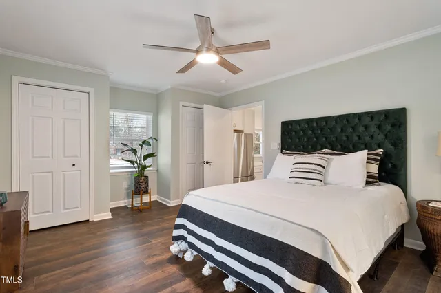 a bedroom with a bed and a chandelier