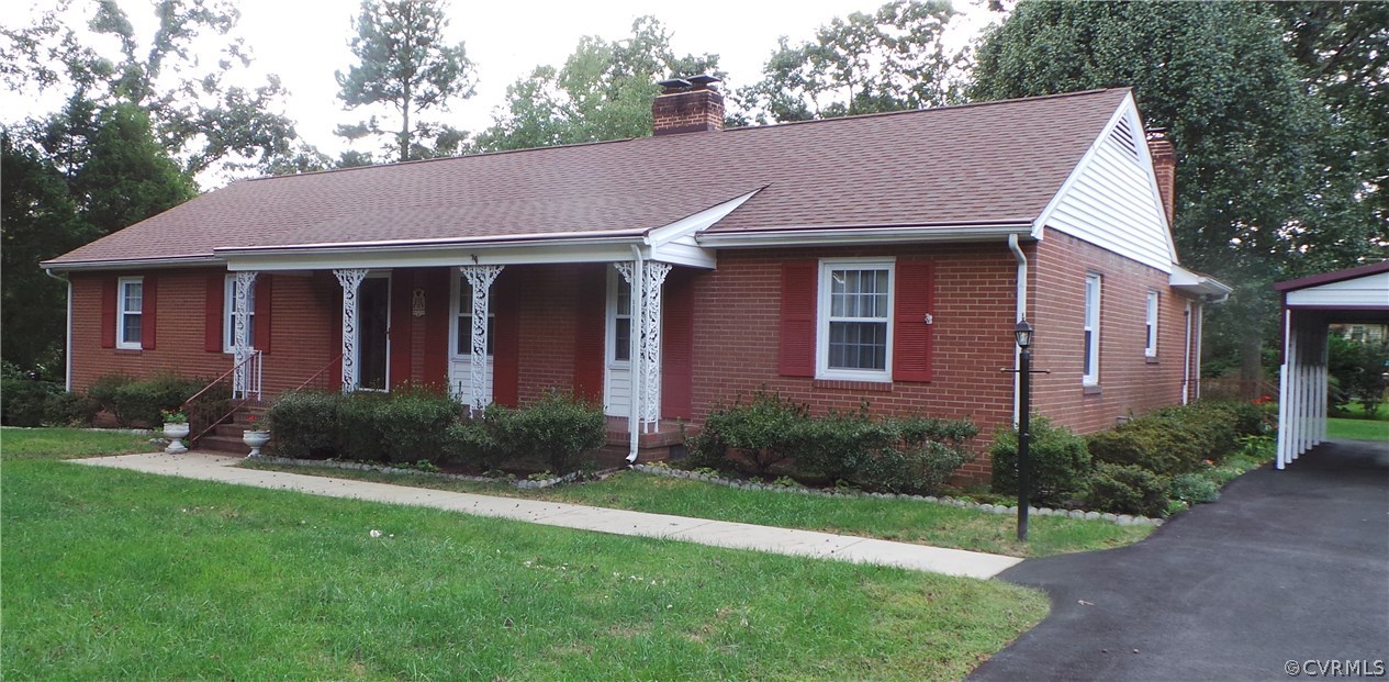 a aerial view of a house next to a yard