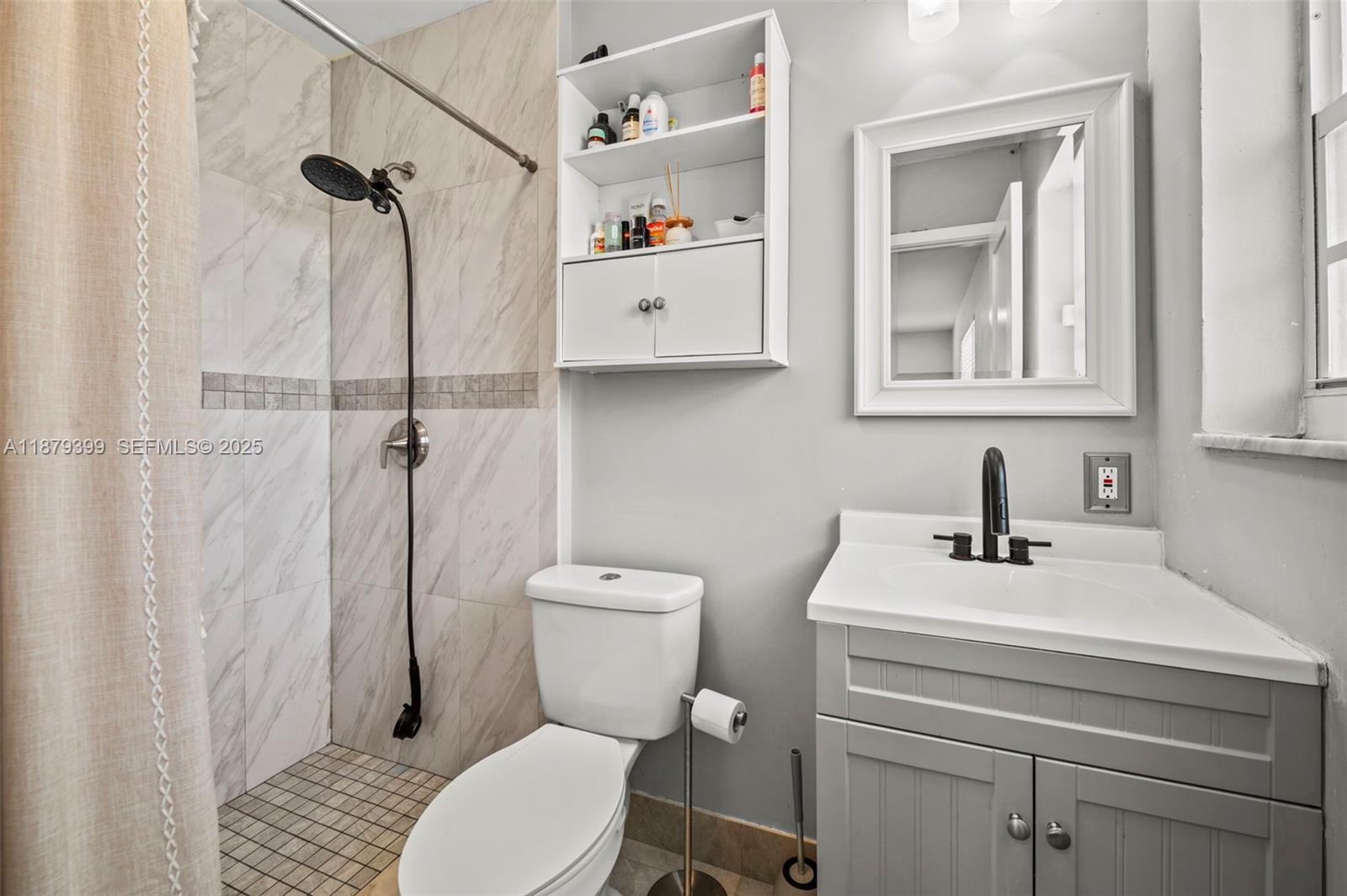17611 Southwest 66th Street Southwest Ranches, FL 33331 - Photo 16 of 45 a bathroom with a sink a toilet and a shower curtain