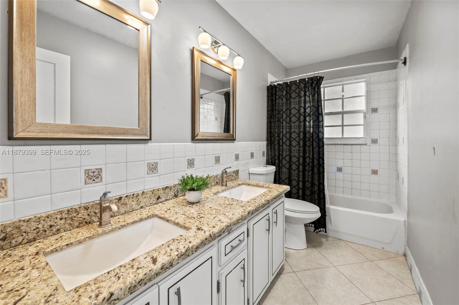 17611 Southwest 66th Street Southwest Ranches, FL 33331 - Photo 22 of 45 a bathroom with a granite countertop sink and a mirror
