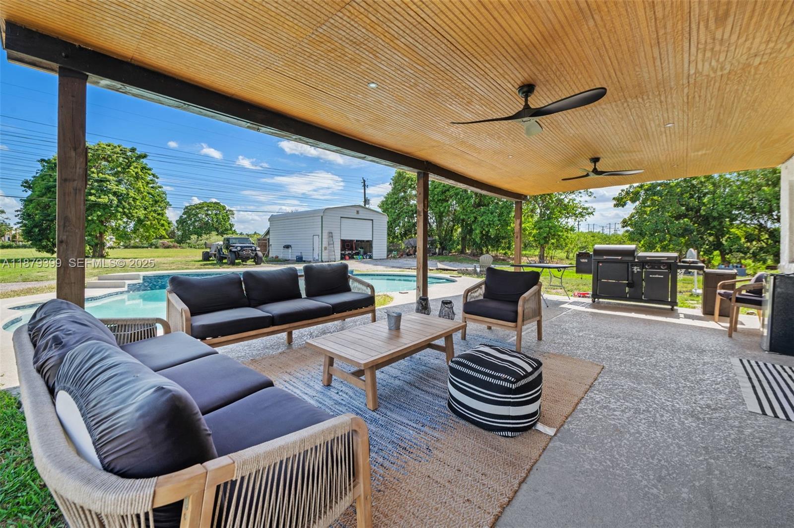 17611 Southwest 66th Street Southwest Ranches, FL 33331 - Photo 23 of 45 a outdoor living space with furniture and a floor to ceiling window