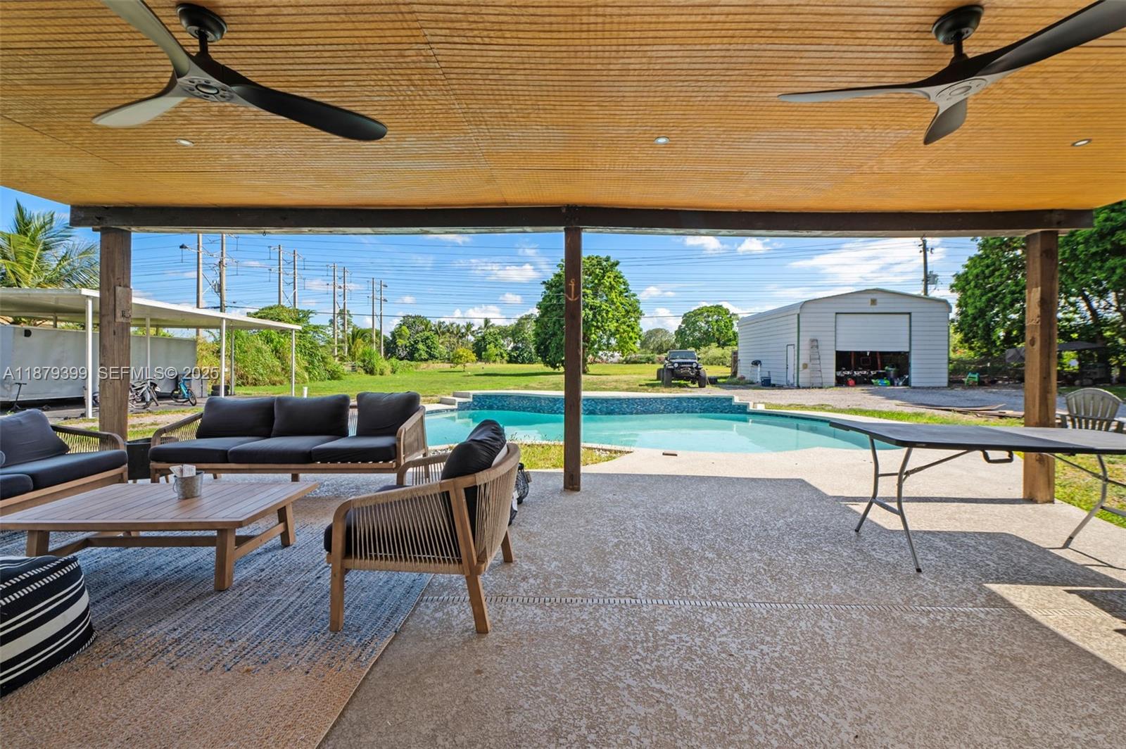 17611 Southwest 66th Street Southwest Ranches, FL 33331 - Photo 24 of 45 a swimming pool with outdoor seating and yard
