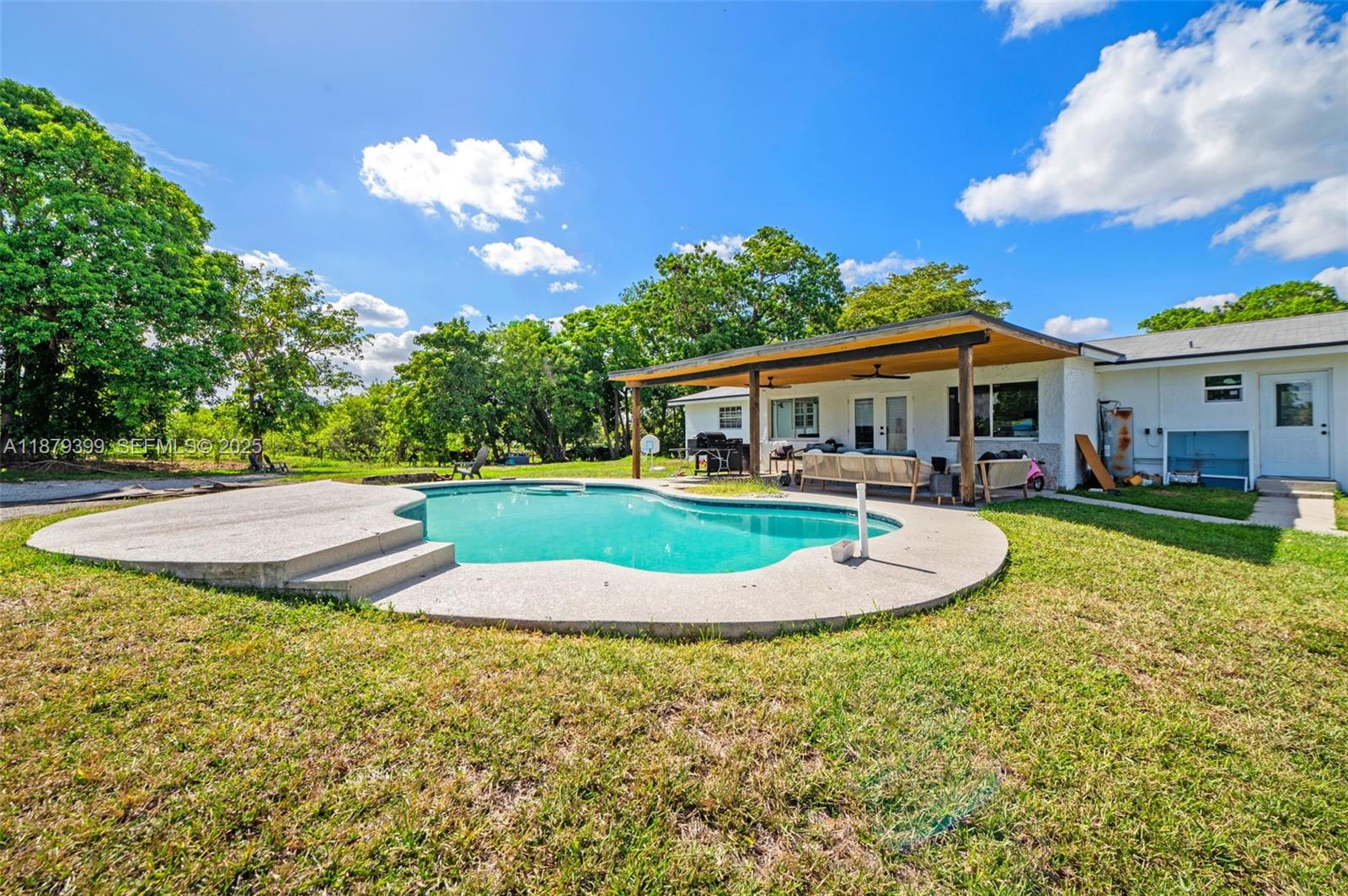 17611 Southwest 66th Street Southwest Ranches, FL 33331 - Photo 27 of 45 a view of a house with swimming pool and porch