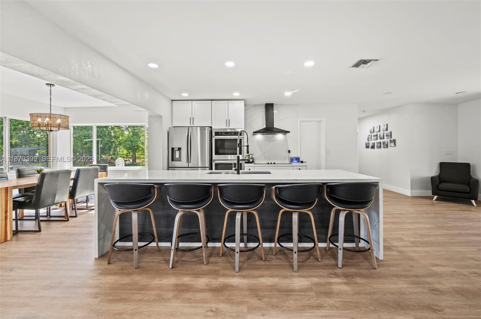 17611 Southwest 66th Street Southwest Ranches, FL 33331 - Photo 3 of 45 a view of a dining room with furniture and wooden floor