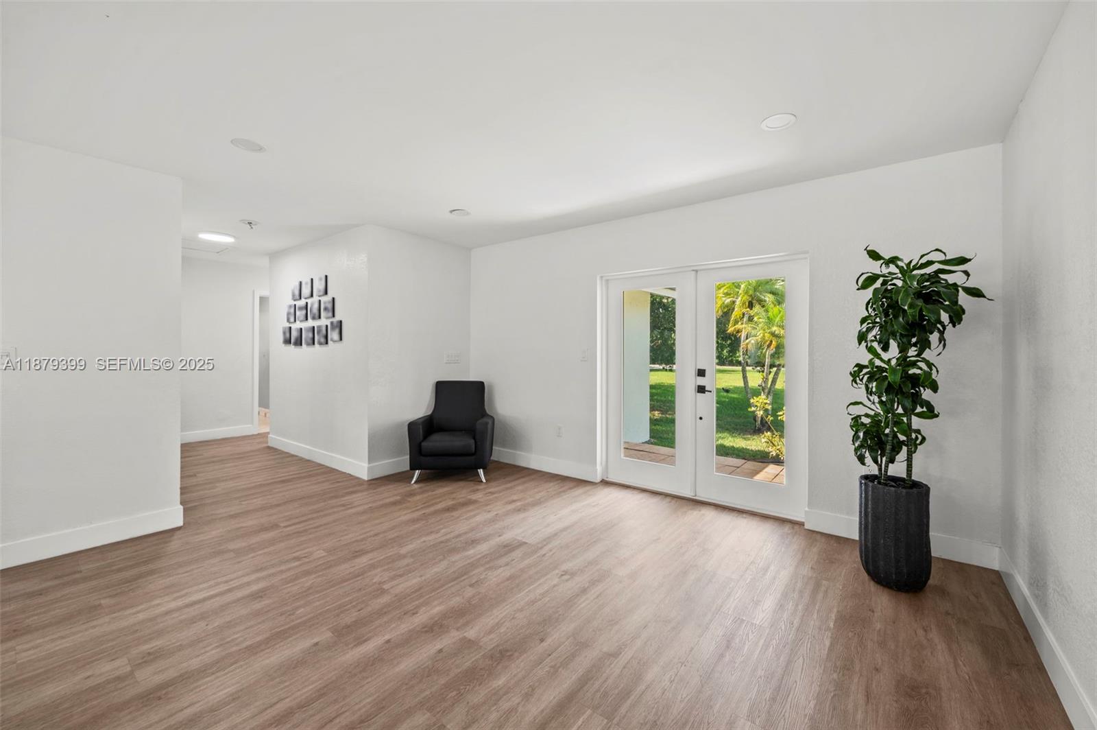17611 Southwest 66th Street Southwest Ranches, FL 33331 - Photo 5 of 45 a view of an empty room with a window and wooden floor