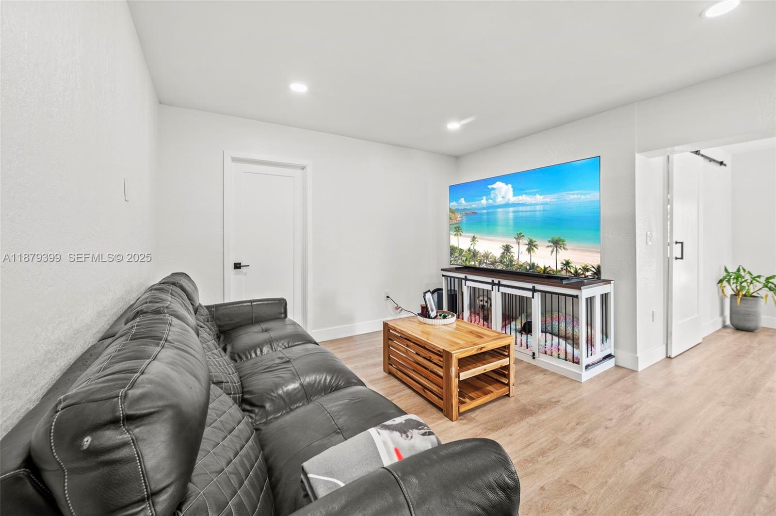17611 Southwest 66th Street Southwest Ranches, FL 33331 - Photo 6 of 45 a living room with furniture and a flat screen tv