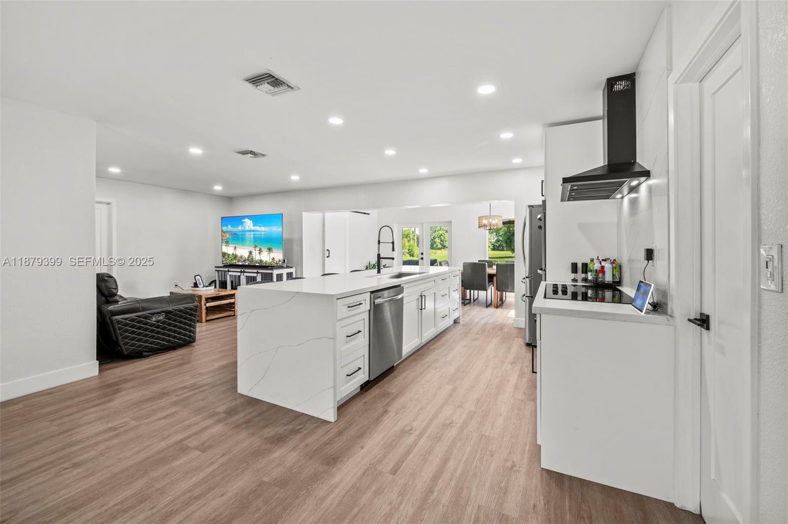 17611 Southwest 66th Street Southwest Ranches, FL 33331 - Photo 7 of 45 a kitchen with stainless steel appliances a stove top oven a sink dishwasher and a refrigerator with wooden floor