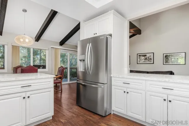 a kitchen with stainless steel appliances a refrigerator and a stove top oven