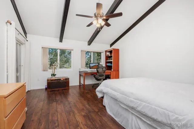 a bedroom with furniture and a large window