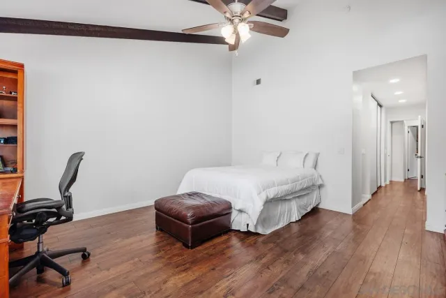 a bedroom with a bed and a chair