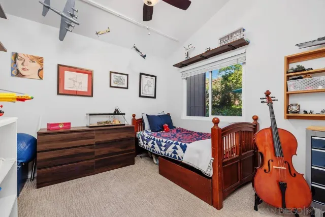 a bedroom with furniture and a large window