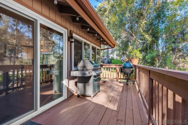 a view of deck with chairs and wooden floor