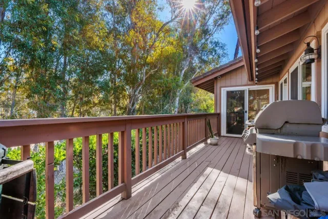 a view of a wooden deck with chairs