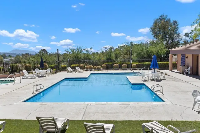 a view of a swimming pool with outdoor seating
