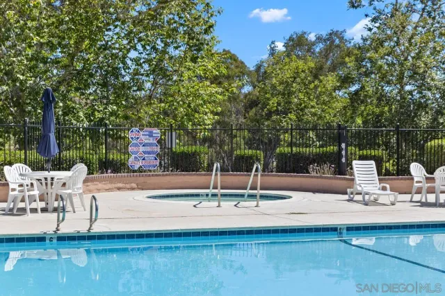 a view of a fountain with a bench in the patio
