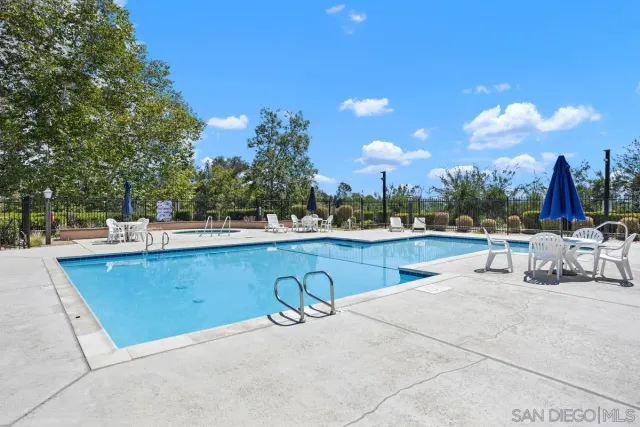 a view of swimming pool with outdoor seating and a yard
