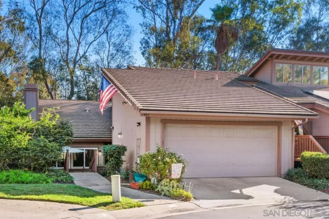 a house that has a tree in front of the house
