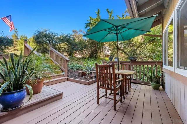 a view of balcony with chairs and wooden floor