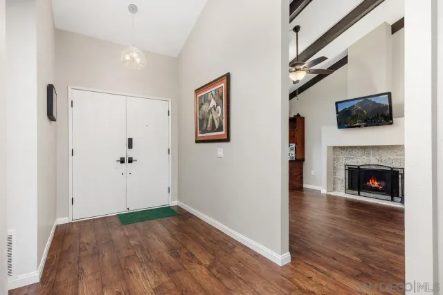 a view of a livingroom with wooden floor and a fireplace