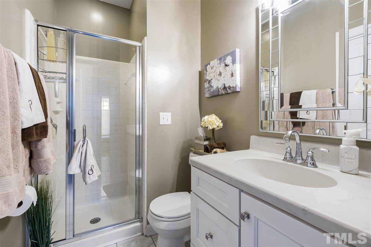 5633 Raddington Street Raleigh, NC 27613 - Photo 12 of 25 a bathroom with a sink toilet and shower