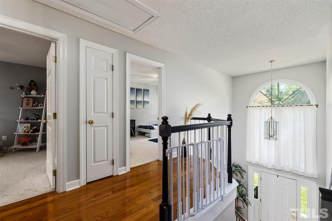 5633 Raddington Street Raleigh, NC 27613 - Photo 13 of 25 a view of a hallway with wooden floor and entryway