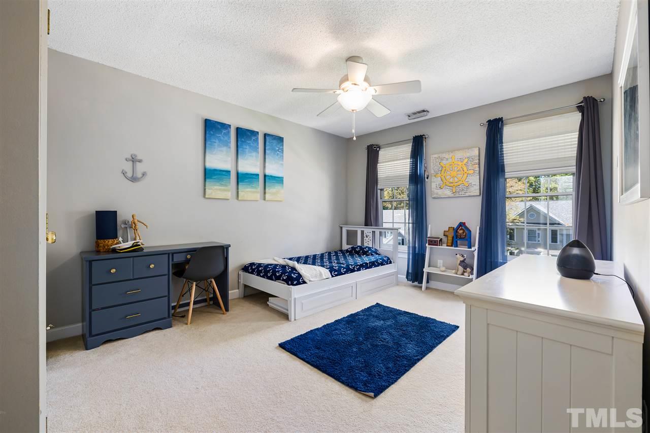 5633 Raddington Street Raleigh, NC 27613 - Photo 17 of 25 a living room with furniture and a chandelier