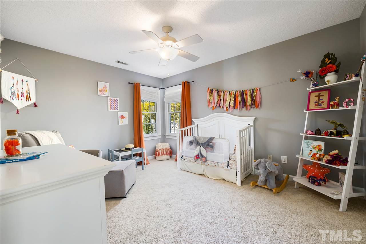 5633 Raddington Street Raleigh, NC 27613 - Photo 18 of 25 a room with furniture and a chandelier