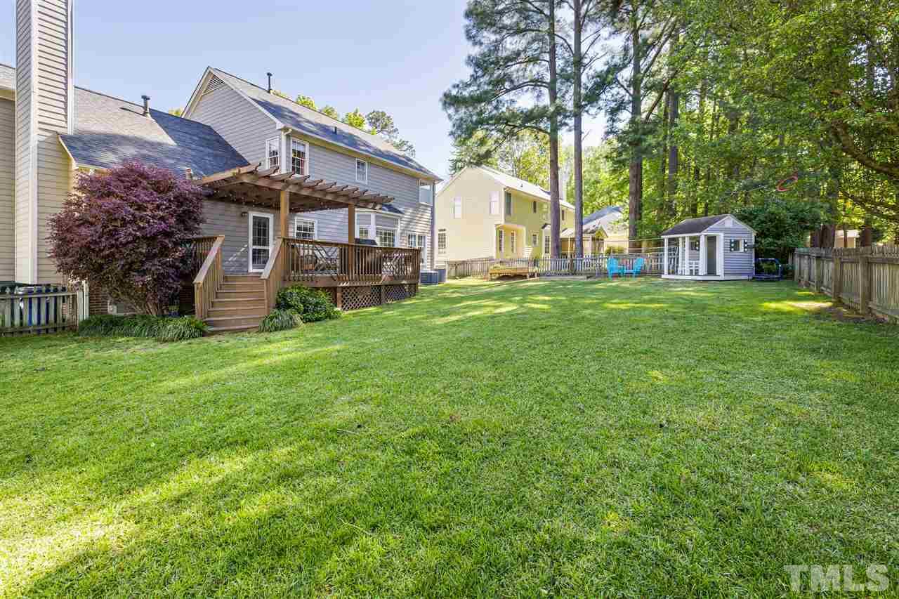 5633 Raddington Street Raleigh, NC 27613 - Photo 22 of 25 a view of a house with a yard and sitting area