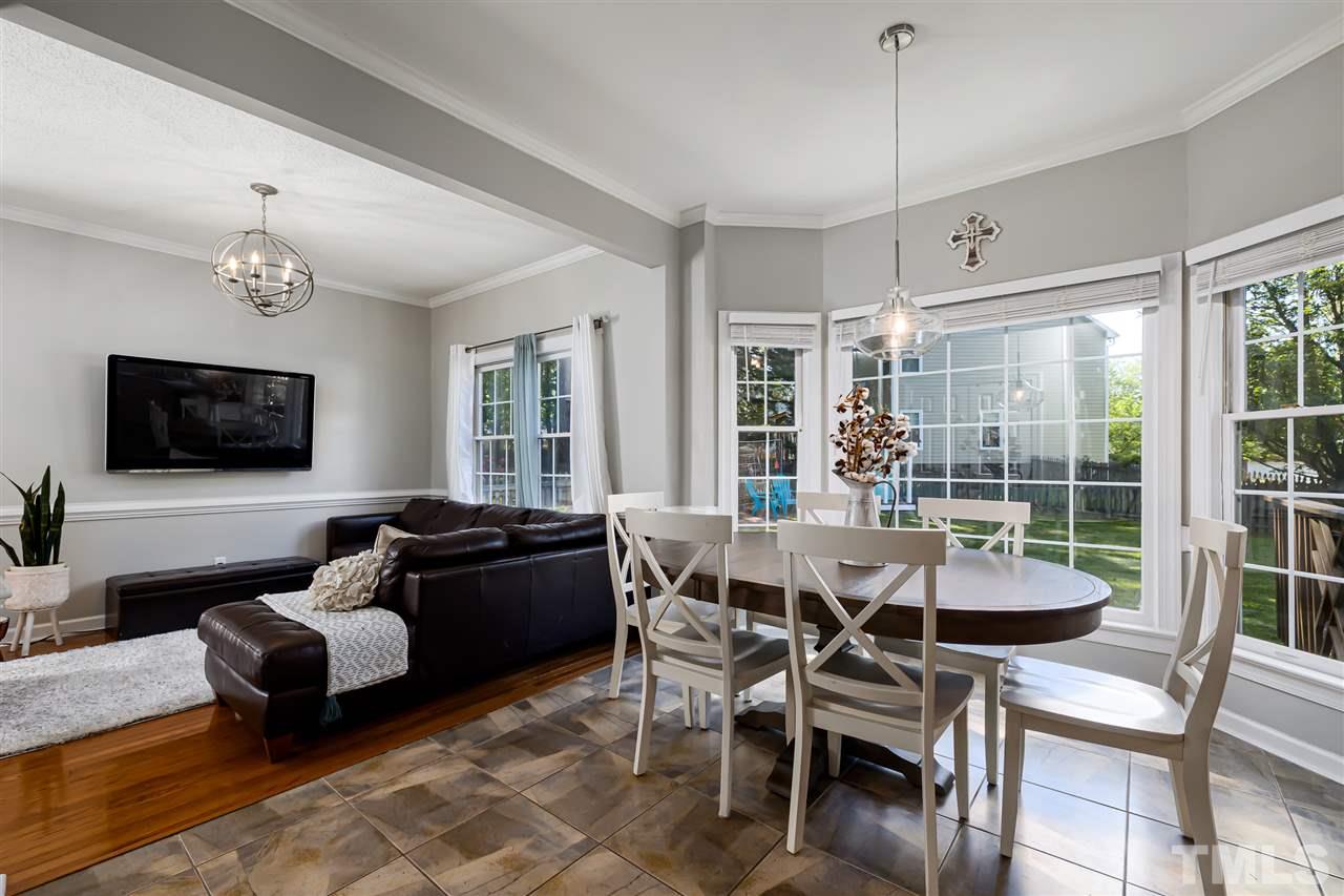 5633 Raddington Street Raleigh, NC 27613 - Photo 5 of 25 a dining room with furniture and wooden floor