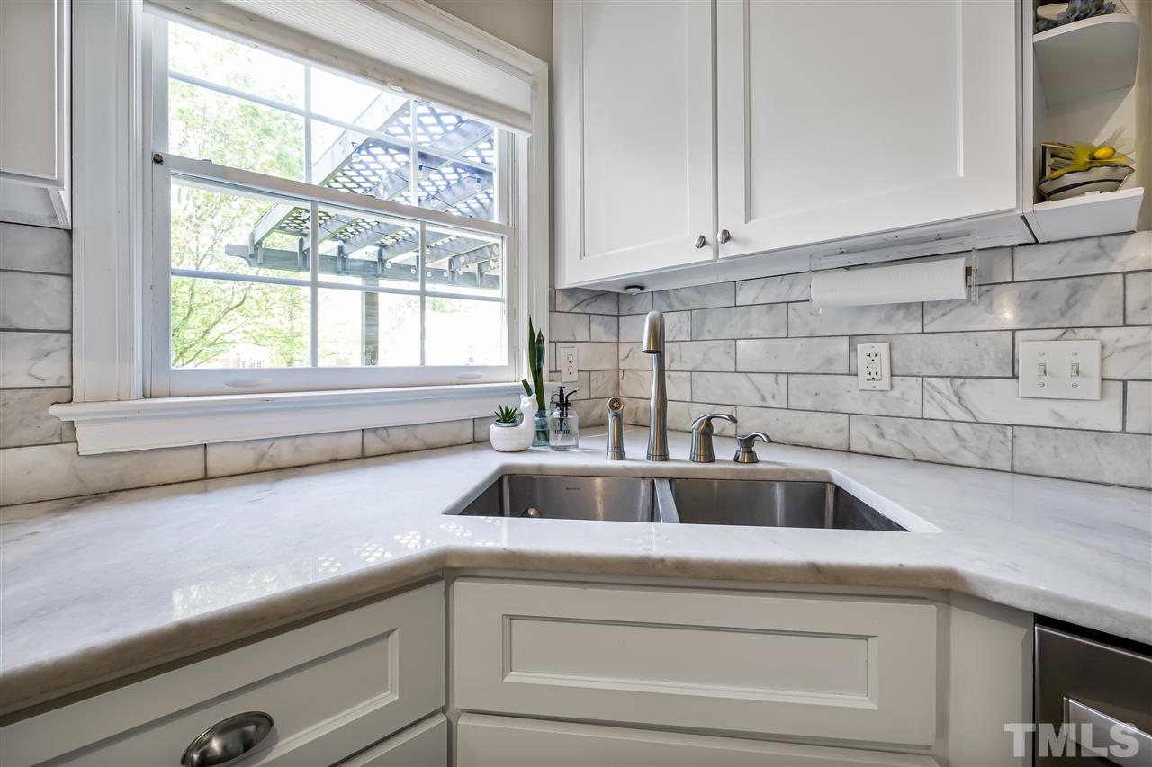 5633 Raddington Street Raleigh, NC 27613 - Photo 6 of 25 a view with granite countertop a sink and a window