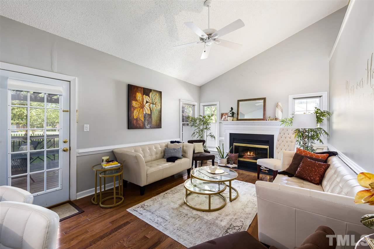 5633 Raddington Street Raleigh, NC 27613 - Photo 7 of 25 a living room with furniture and a fireplace