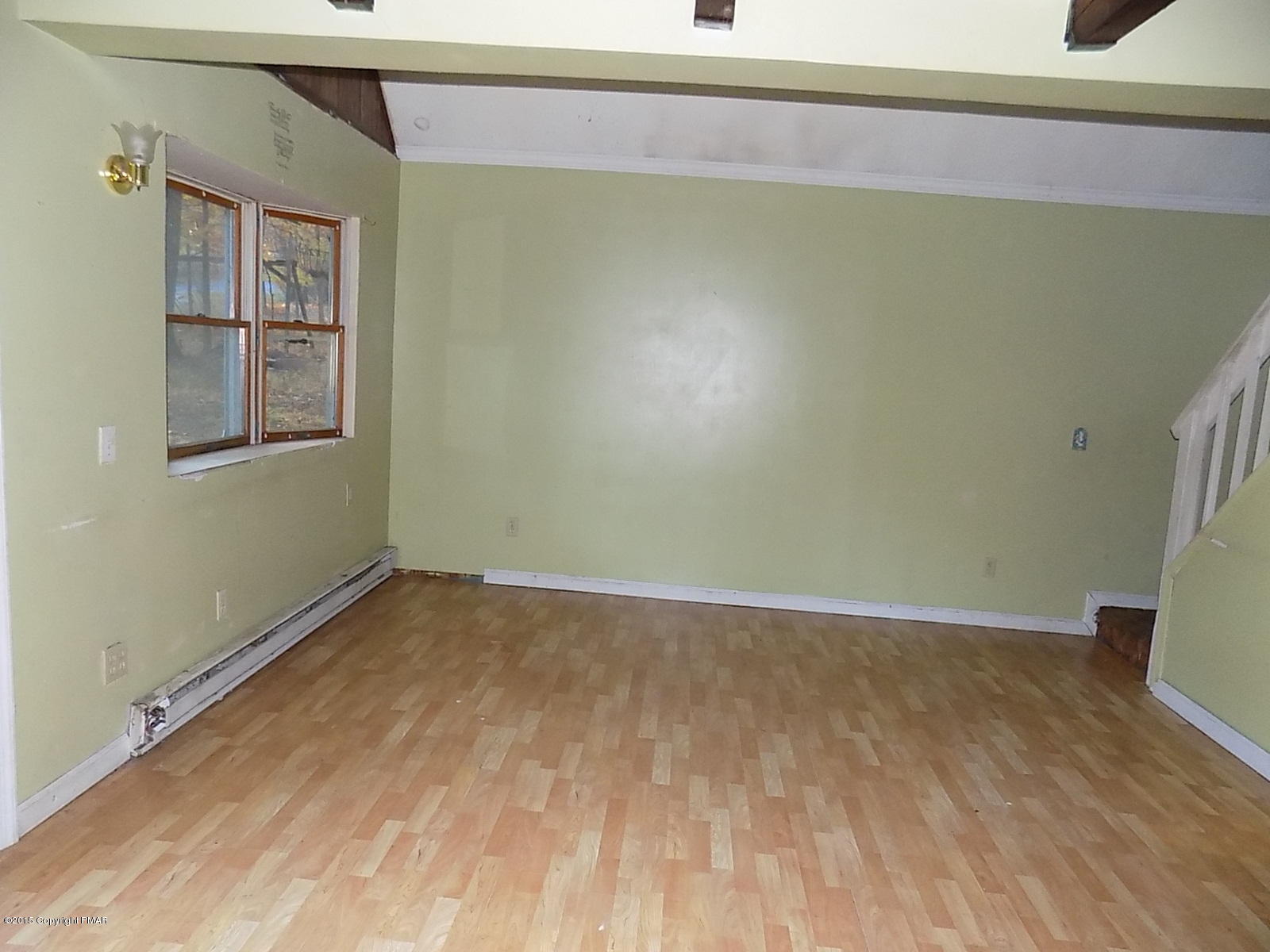 521 Gold Finch Road Bushkill, PA 18324 - Photo 14 of 14 a view of an empty room with wooden floor and a window