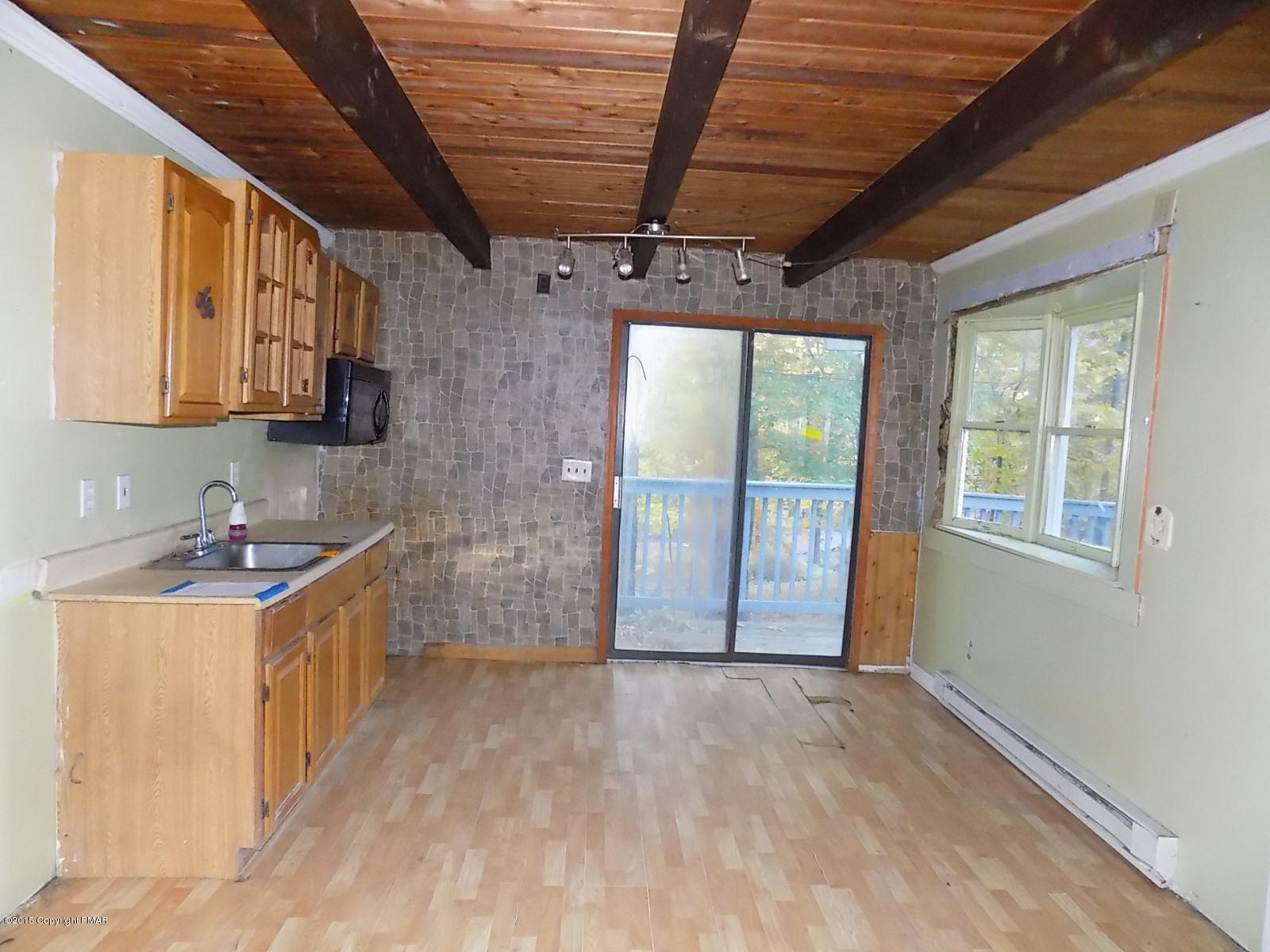 521 Gold Finch Road Bushkill, PA 18324 - Photo 3 of 14 a view of a kitchen with a sink and wooden cabinets