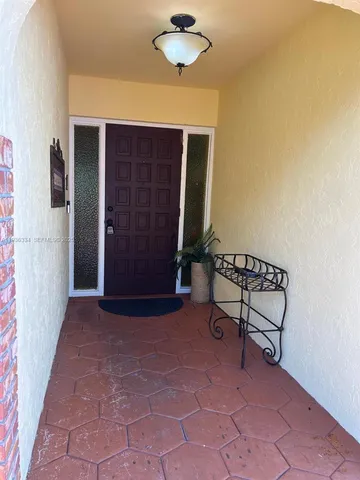 a view of backyard with a table and a chair